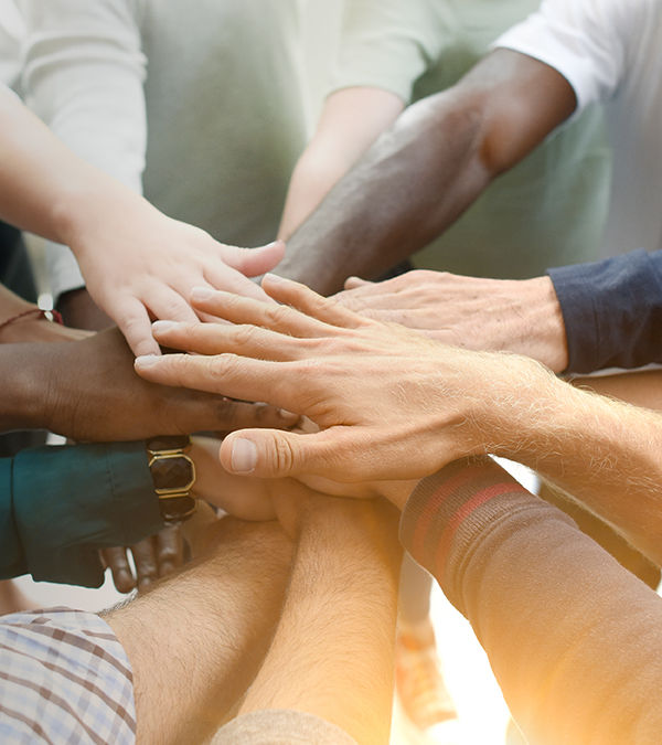Diverse team joining their hands